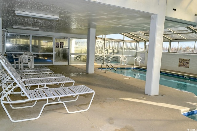 view of swimming pool with a lanai and a patio