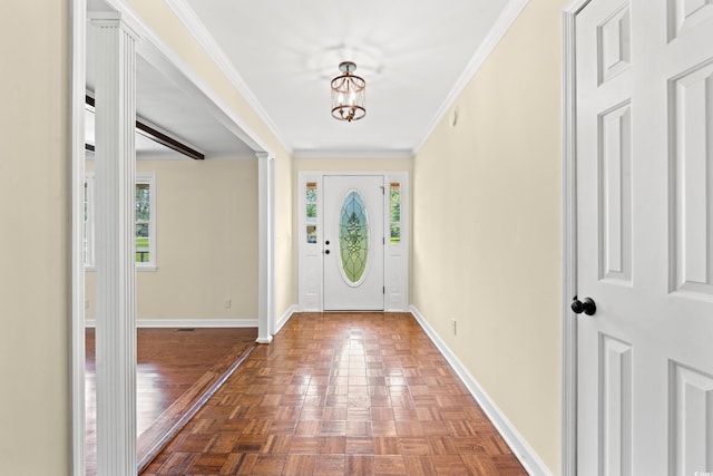 foyer with parquet flooring, an inviting chandelier, and crown molding