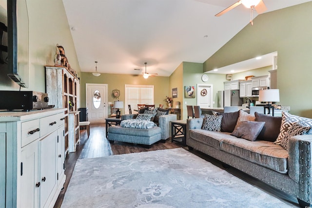 living room with ceiling fan, lofted ceiling, and dark hardwood / wood-style floors