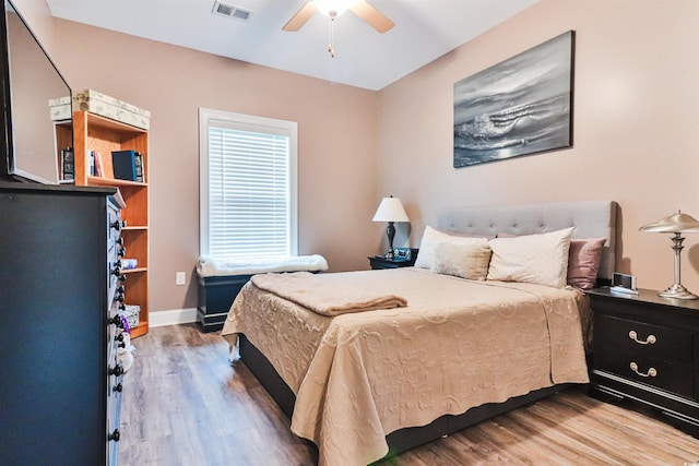 bedroom with ceiling fan and hardwood / wood-style flooring