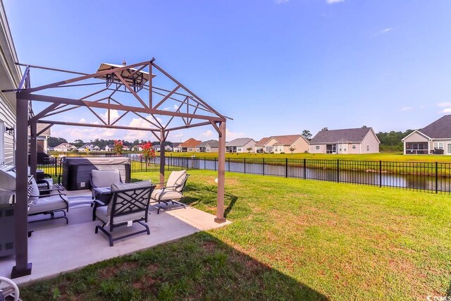 view of yard with a water view and a patio area