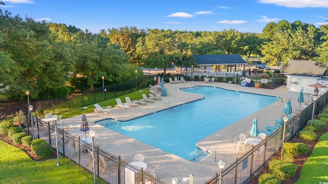 view of swimming pool featuring a yard and a patio area