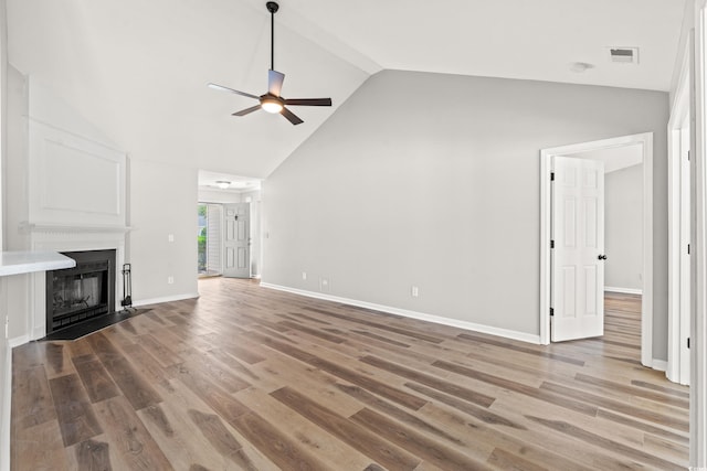 unfurnished living room featuring high vaulted ceiling, hardwood / wood-style flooring, and ceiling fan