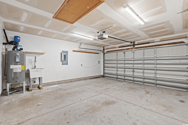 garage with a garage door opener, electric panel, and electric water heater