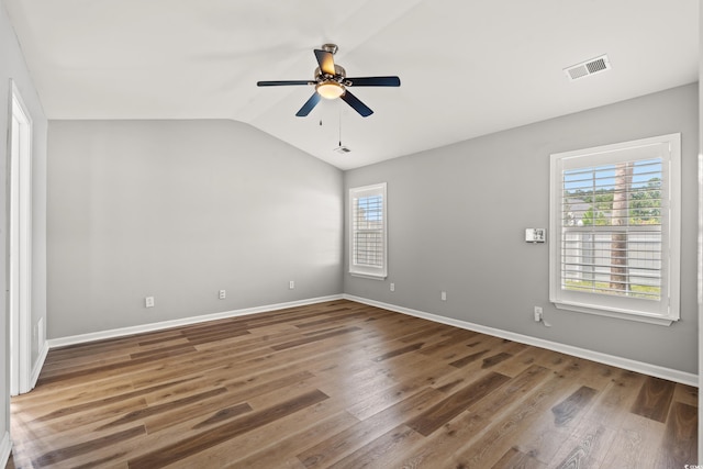 unfurnished room with ceiling fan, hardwood / wood-style flooring, and vaulted ceiling