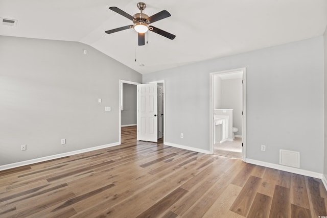 unfurnished bedroom with hardwood / wood-style floors, ceiling fan, and ensuite bathroom