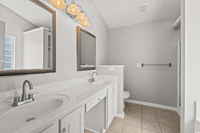 bathroom featuring vanity, toilet, and tile patterned floors