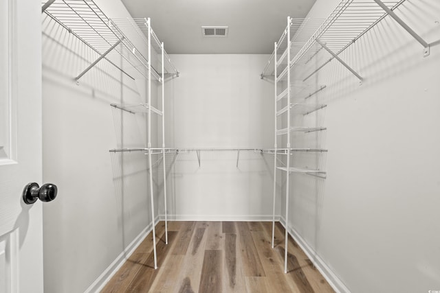 walk in closet featuring light hardwood / wood-style flooring