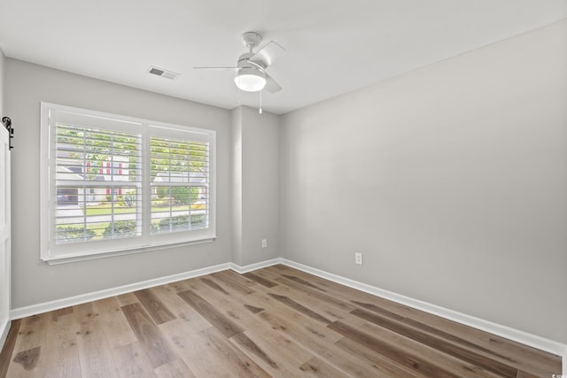 unfurnished room featuring ceiling fan and hardwood / wood-style flooring