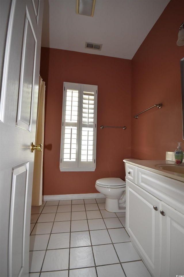 bathroom with visible vents, baseboards, toilet, tile patterned flooring, and vanity