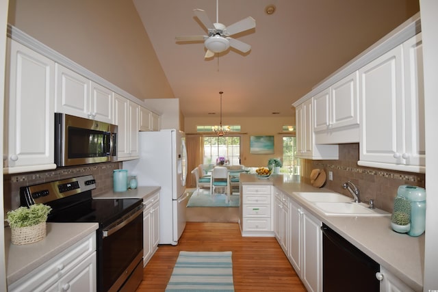 kitchen featuring a sink, white cabinets, light countertops, appliances with stainless steel finishes, and light wood-type flooring