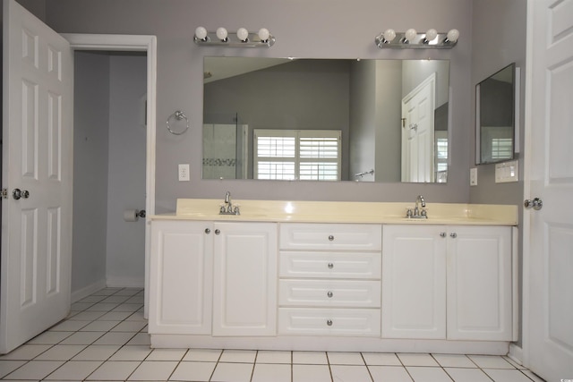 full bath featuring tile patterned floors, a sink, and double vanity