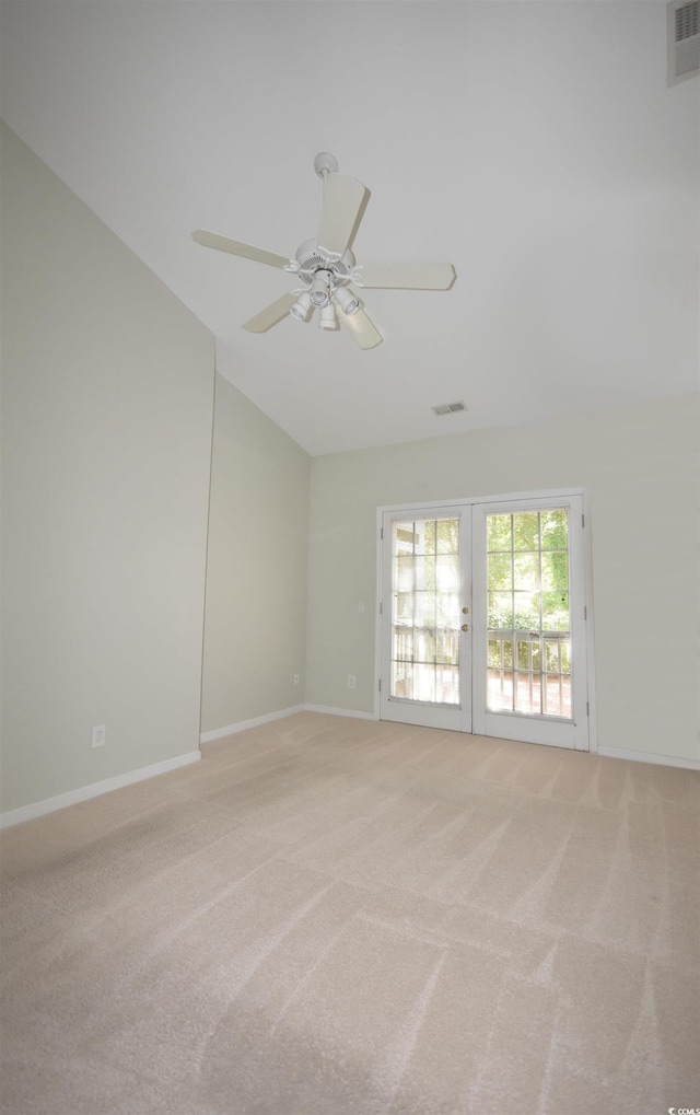 empty room with light carpet, french doors, vaulted ceiling, and visible vents