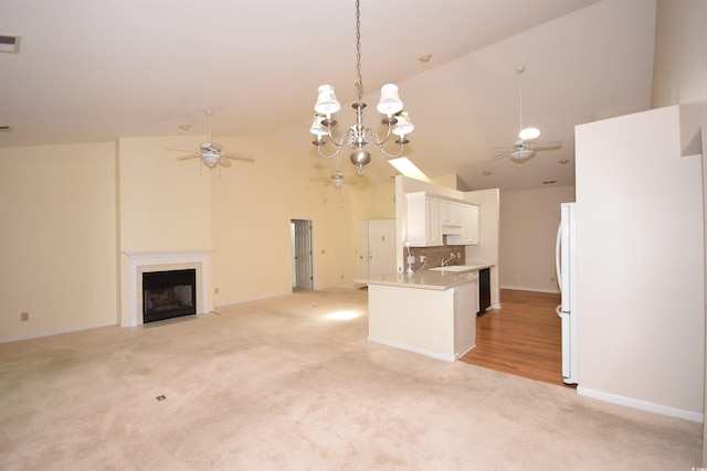 kitchen featuring light carpet, ceiling fan, and freestanding refrigerator