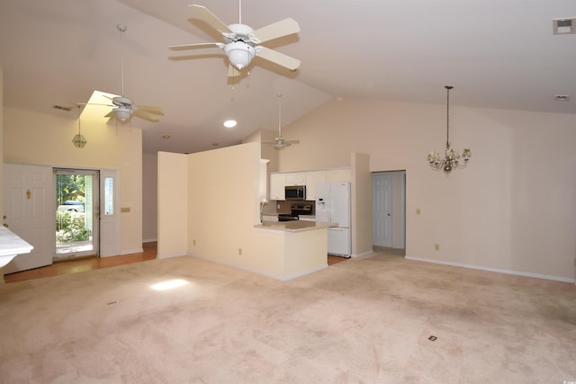 kitchen with stainless steel appliances, open floor plan, white cabinets, light carpet, and high vaulted ceiling