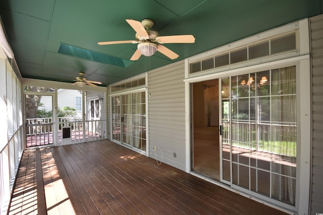 unfurnished sunroom featuring ceiling fan