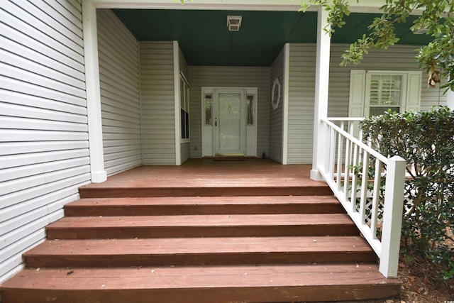 entrance to property with a porch and a carport