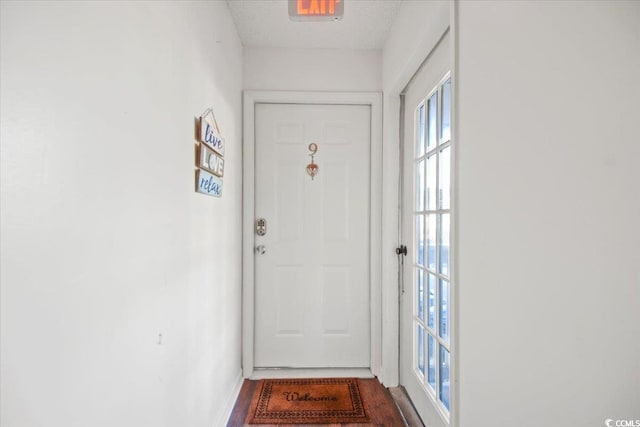 doorway featuring a textured ceiling