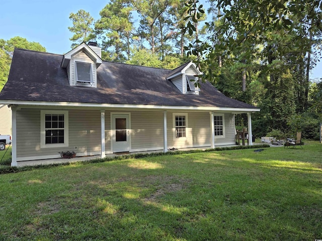 cape cod home with a front lawn