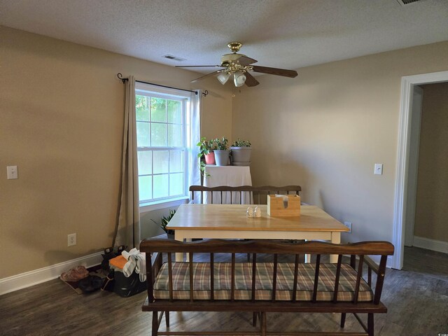dining room featuring ceiling fan, dark hardwood / wood-style flooring, and a textured ceiling