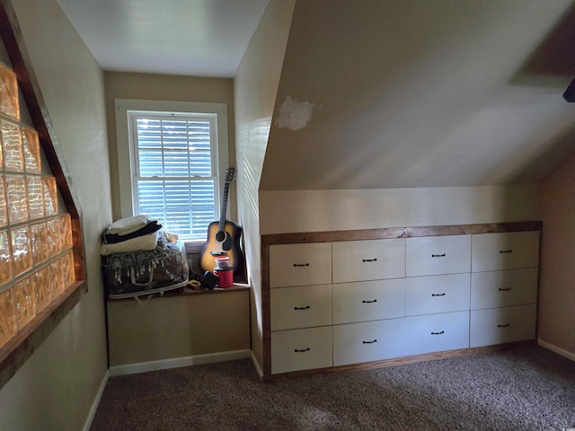 bonus room featuring vaulted ceiling and dark colored carpet