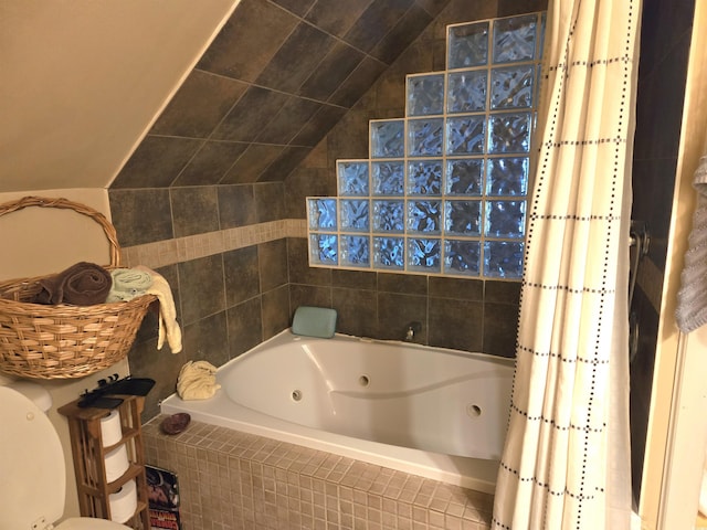 bathroom with vaulted ceiling and shower / tub combo