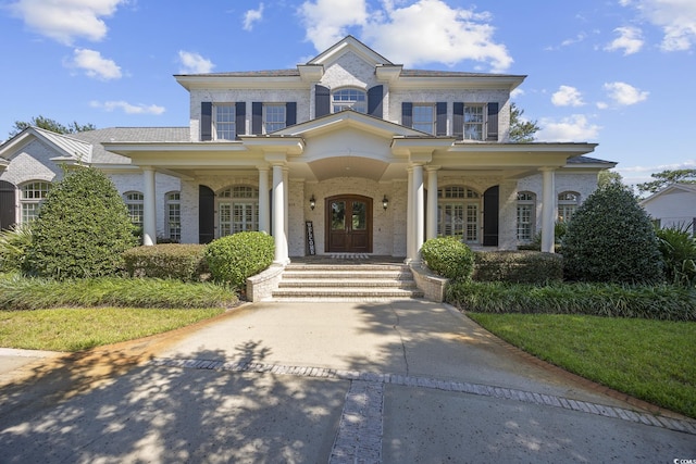 9318 Cove Dr, Myrtle Beach, SC 29572 - view of front of house featuring brick siding, a porch, and french doors