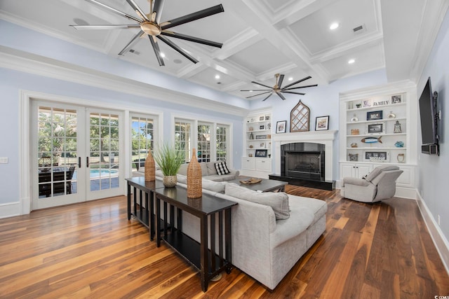 living area with built in shelves, french doors, visible vents, coffered ceiling, and beamed ceiling