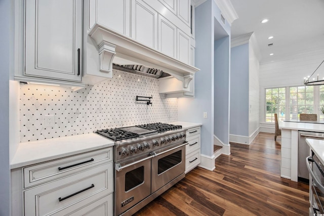 kitchen with a chandelier, range with two ovens, ornamental molding, backsplash, and dark wood finished floors