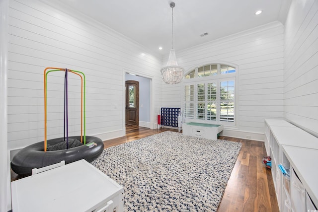 interior space featuring visible vents, dark wood finished floors, baseboards, ornamental molding, and recessed lighting