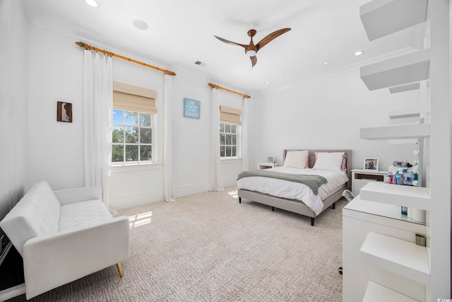 bedroom featuring ceiling fan, ornamental molding, and carpet floors