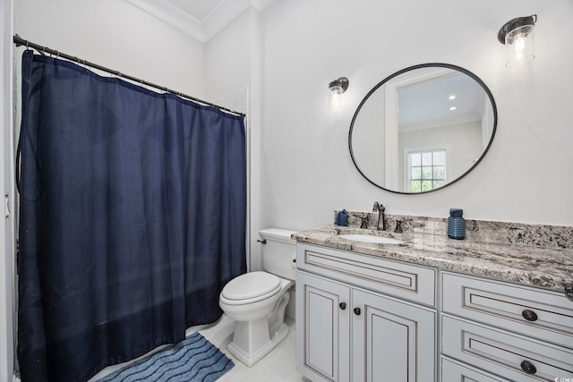 bathroom with crown molding, vanity, and toilet