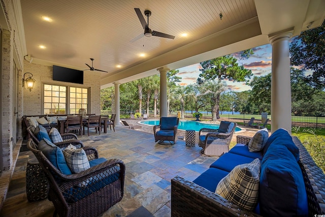 view of patio / terrace with a fenced in pool, fence, an outdoor living space, and a ceiling fan