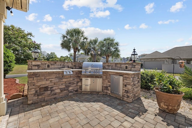 view of patio featuring an outdoor kitchen and a grill