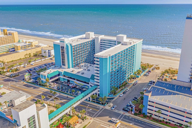 aerial view with a water view and a beach view