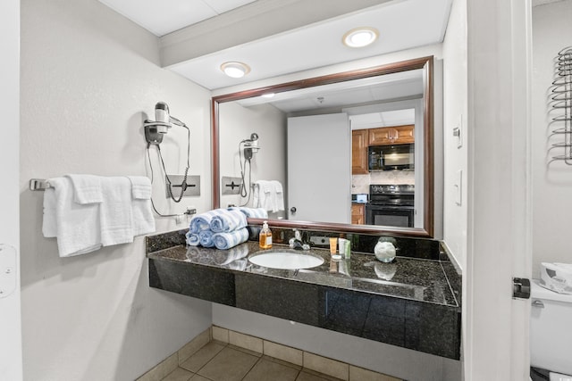 bathroom with tile patterned flooring and vanity