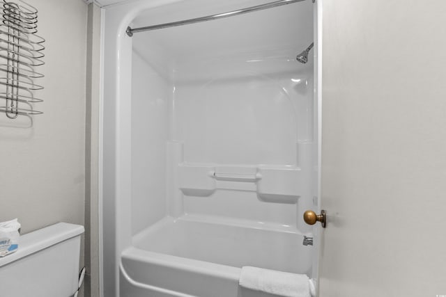 bathroom featuring shower / bathtub combination and toilet