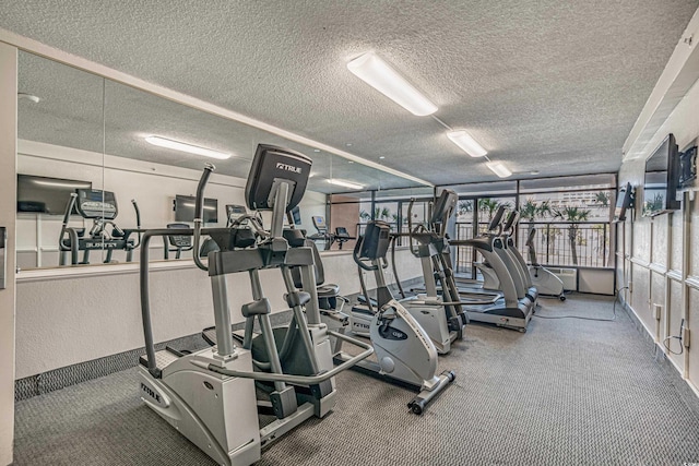 exercise room featuring a textured ceiling