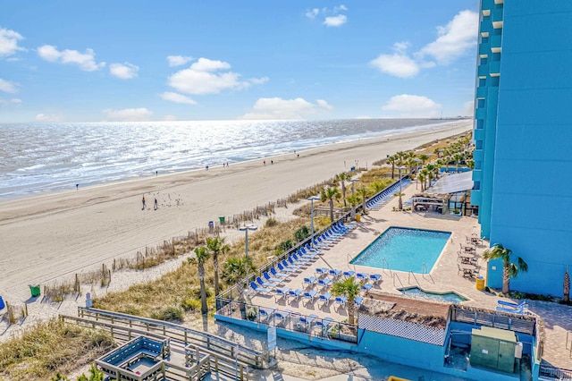 bird's eye view with a water view and a view of the beach