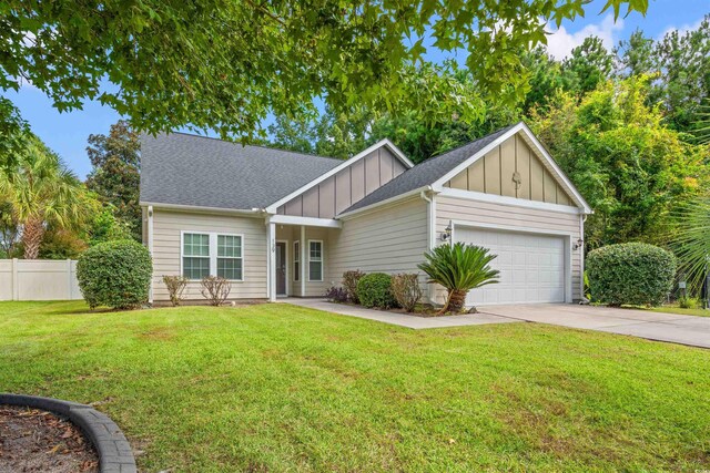 view of front of property featuring a garage and a front lawn