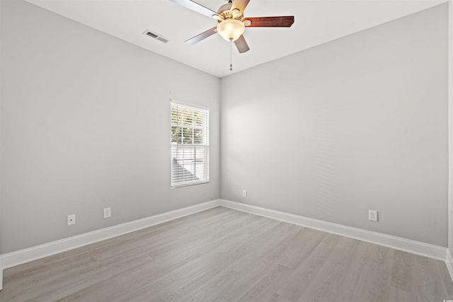 unfurnished room featuring a ceiling fan, visible vents, light wood finished floors, and baseboards