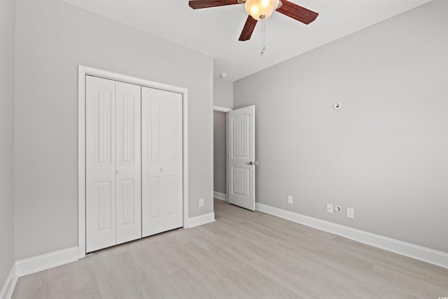 unfurnished bedroom with a closet, ceiling fan, baseboards, and wood finished floors