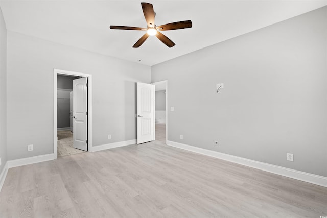 unfurnished bedroom with a ceiling fan, light wood-style flooring, baseboards, and ensuite bathroom