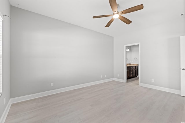 unfurnished bedroom featuring ceiling fan, light wood-type flooring, ensuite bath, and baseboards