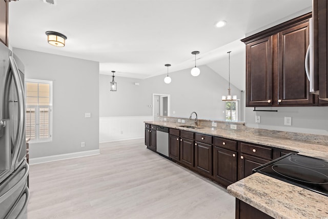 kitchen with dark brown cabinetry, light wood-style flooring, appliances with stainless steel finishes, pendant lighting, and a sink