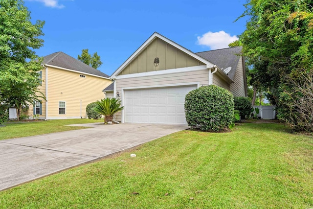 view of front facade featuring board and batten siding, a front yard, driveway, and an attached garage