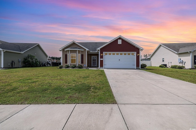 ranch-style house with a garage and a front lawn