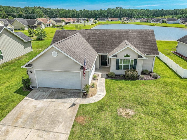 ranch-style house featuring a water view, a front yard, and a garage