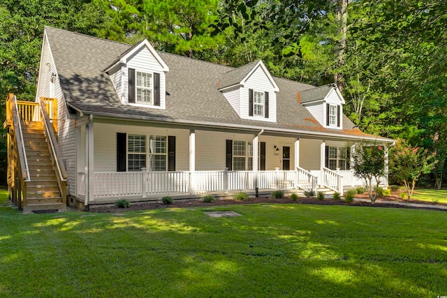 new england style home with a porch and a front lawn