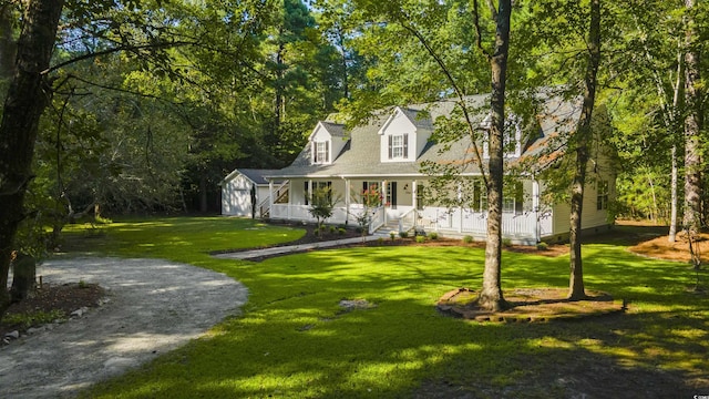 3758 Loblolly Ave, Little River, SC 29566 - cape cod home featuring a storage shed, an outbuilding, a porch, and a front lawn